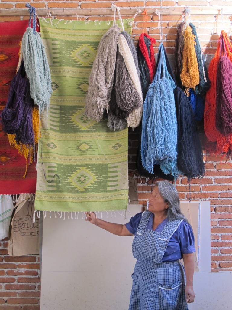 Adelaide in her rug-weaving shop. She is one of the women helped by En Via's micro-finance program.